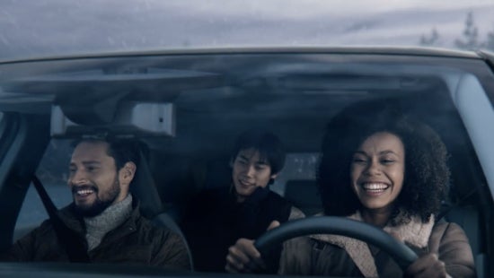 Three passengers riding in a vehicle and smiling | Cherokee County Nissan in Holly Springs GA