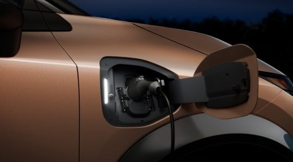 Close-up image of charging cable plugged in | Cherokee County Nissan in Holly Springs GA